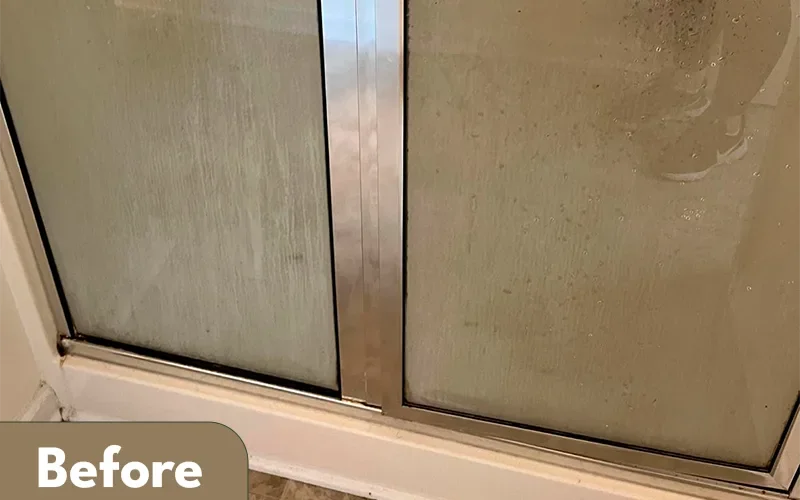 Glass shower door cleaned by Lara Maids, before