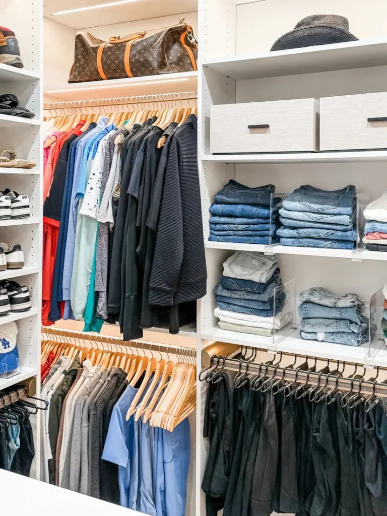 Closet organized with matching hangers and folded jeans in Raleigh, NC