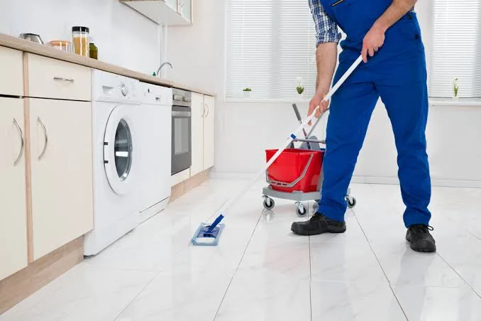 Mopping kitchen floors during a deep clean in Raleigh, NC