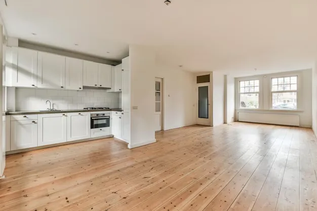 Empty kitchen and wood floors after move-out cleaning in Durham, NC