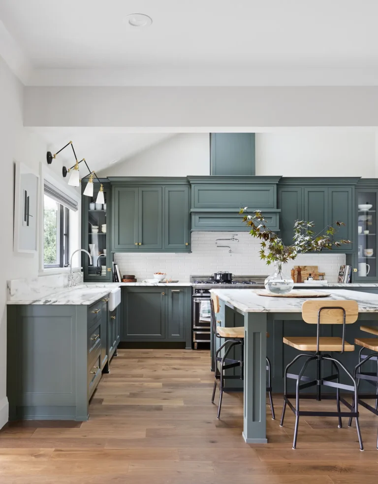 Green gray painted kitchen cabinets with brass hardware in Raleigh, NC