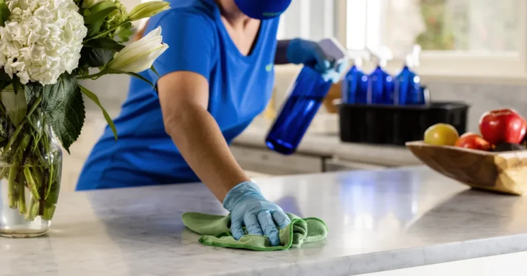 Housekeeper wiping a marble kitchen counter in Holly Springs, NC