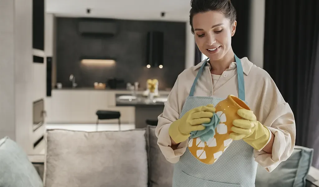 Lara Maids cleaner smiling while cleaning a home in Cary, NC