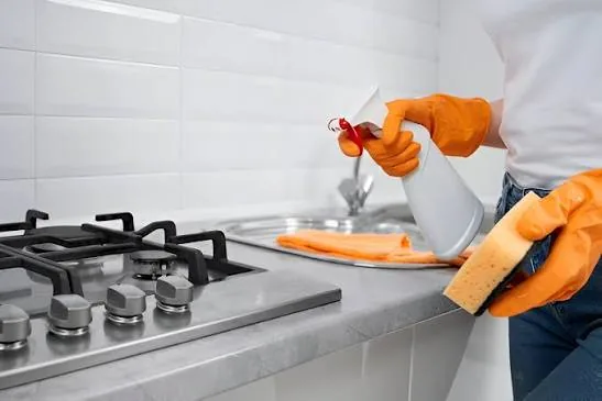 Degreasing a gas stovetop during a deep clean in Cary, NC