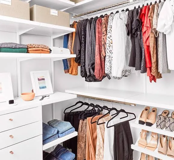 Walk-in closet organized by type and color in Holly Springs, NC
